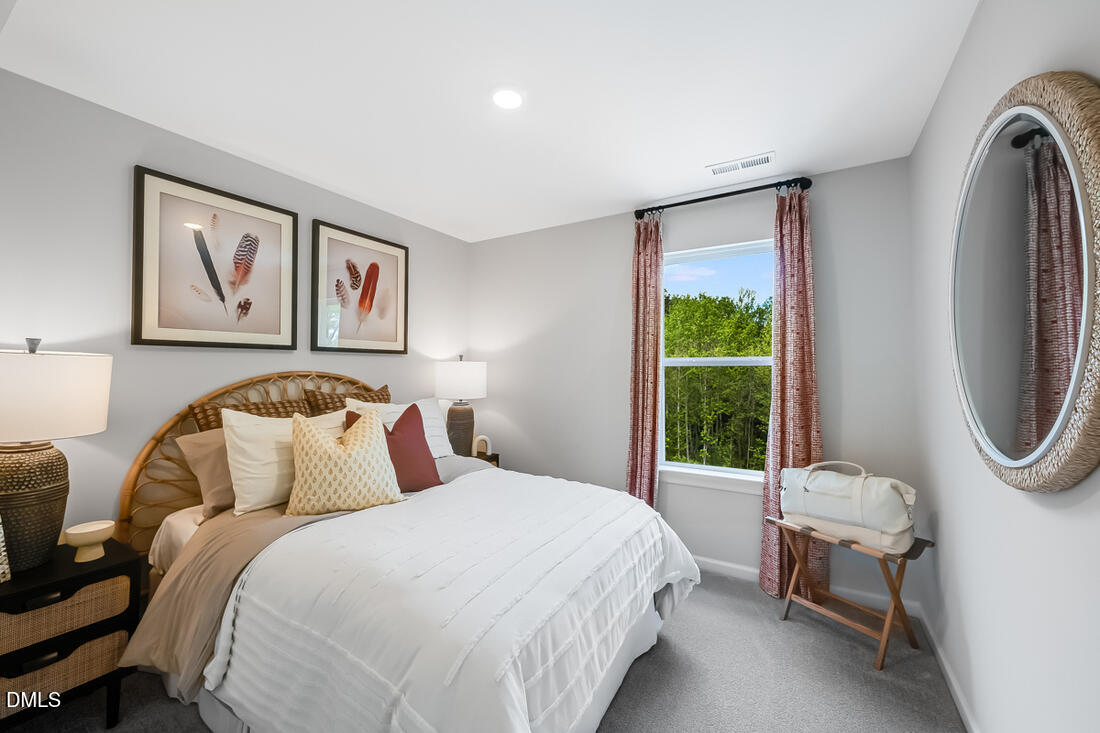 1324 West Garner Road, Unit 103 Garner, NC 27529 - Photo 25 of 27 a bedroom with a bed a couch and a window