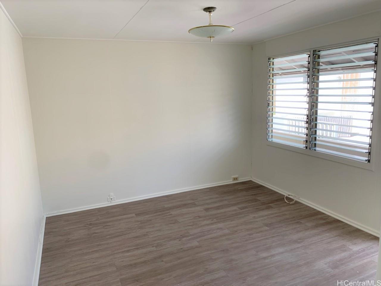 2956 Varsity Circle, Unit E Honolulu, HI 96826 - Photo 1 of 1 an empty room with wooden floor and windows