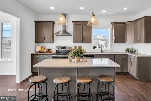 a kitchen with granite countertop a table chairs stove and cabinets