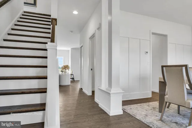 a view of entryway with wooden floor and stairs