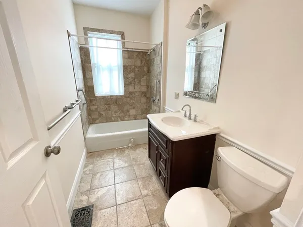 a bathroom with a sink a toilet and bathtub