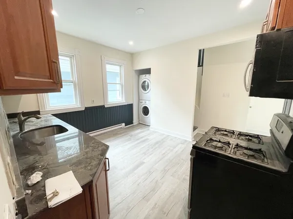 a kitchen with granite countertop a stove and a refrigerator