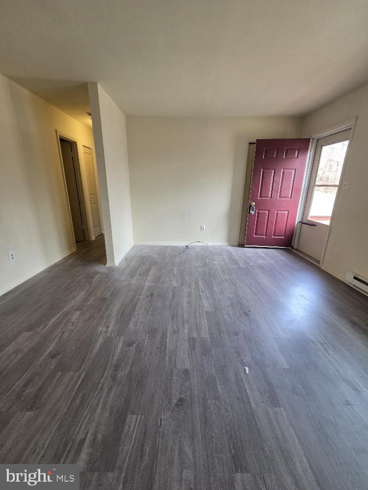 10408 Leavells Road Fredericksburg, VA 22407 - Photo 4 of 10 a view of an empty room and wooden floor with windows
