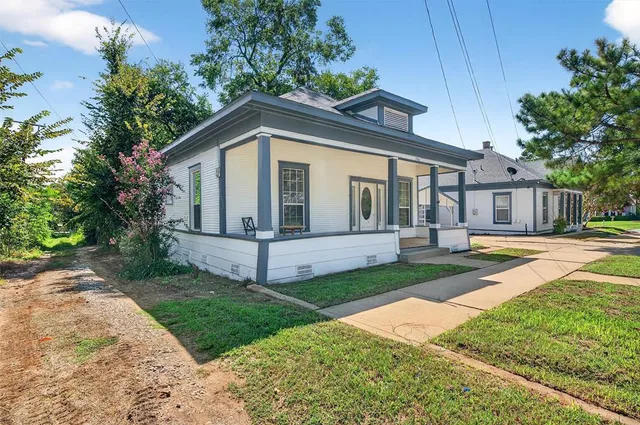 a front view of a house with a yard and porch