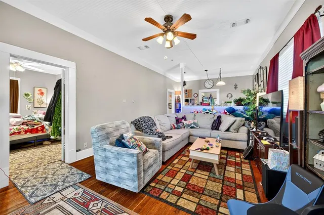 a living room with furniture fireplace and a window