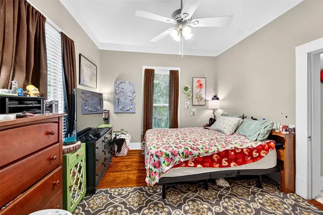 a bedroom with a bed dresser and a window