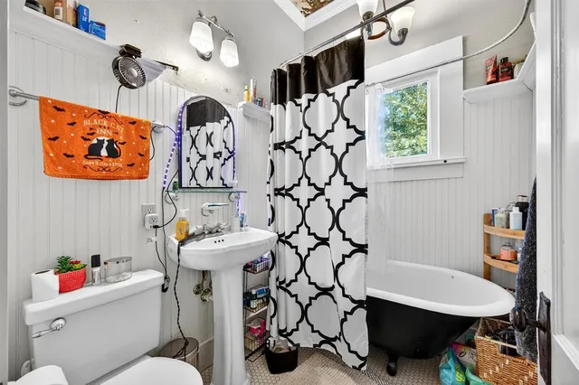 a bathroom with a sink mirror vanity and toilet