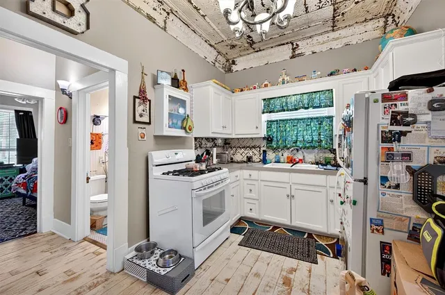 a kitchen with stainless steel appliances a stove a refrigerator and a cabinets