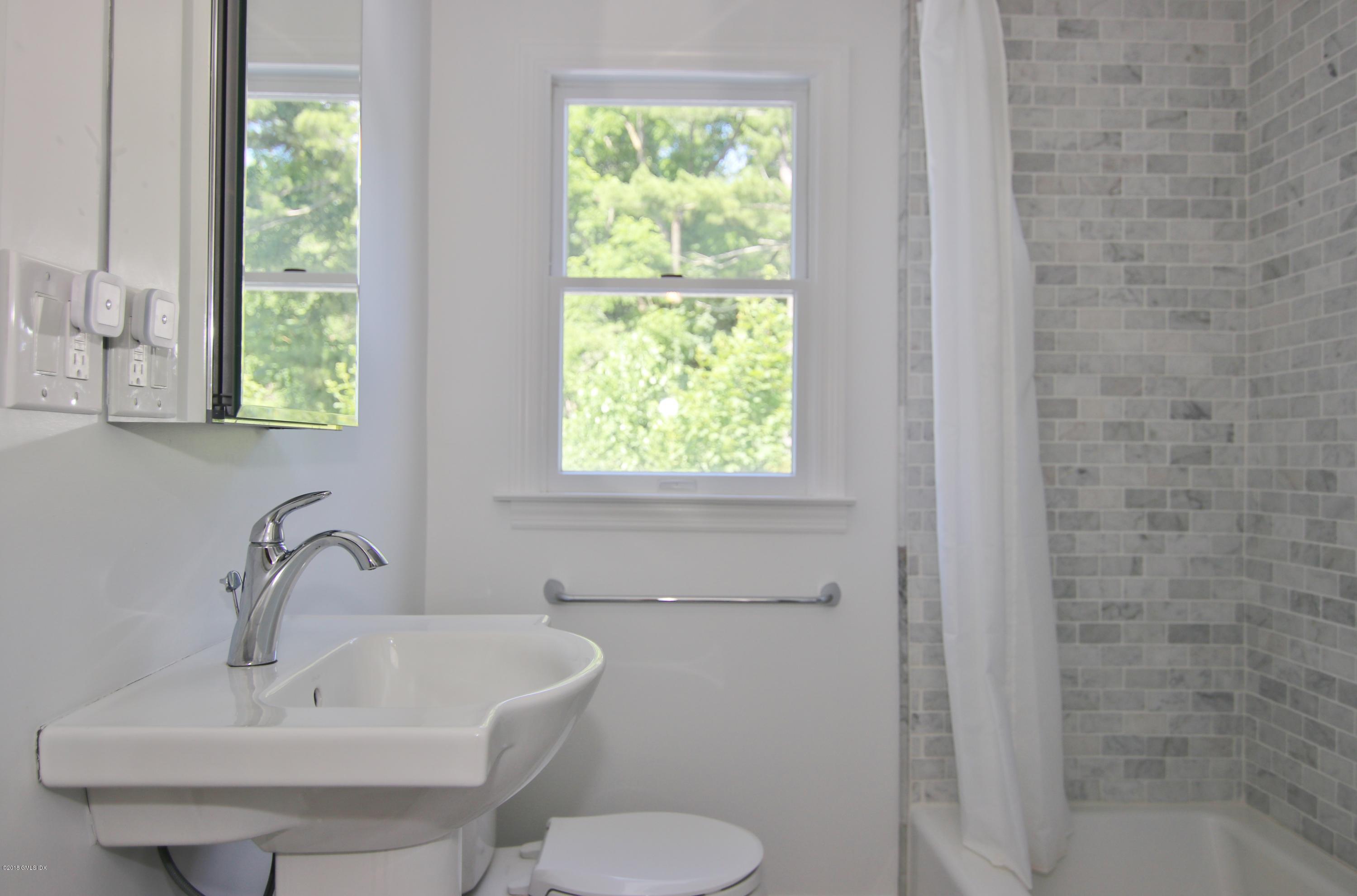 9 Bonwit Road Riverside, CT 06878 - Photo 18 of 29 a bathroom with a sink a toilet and a window