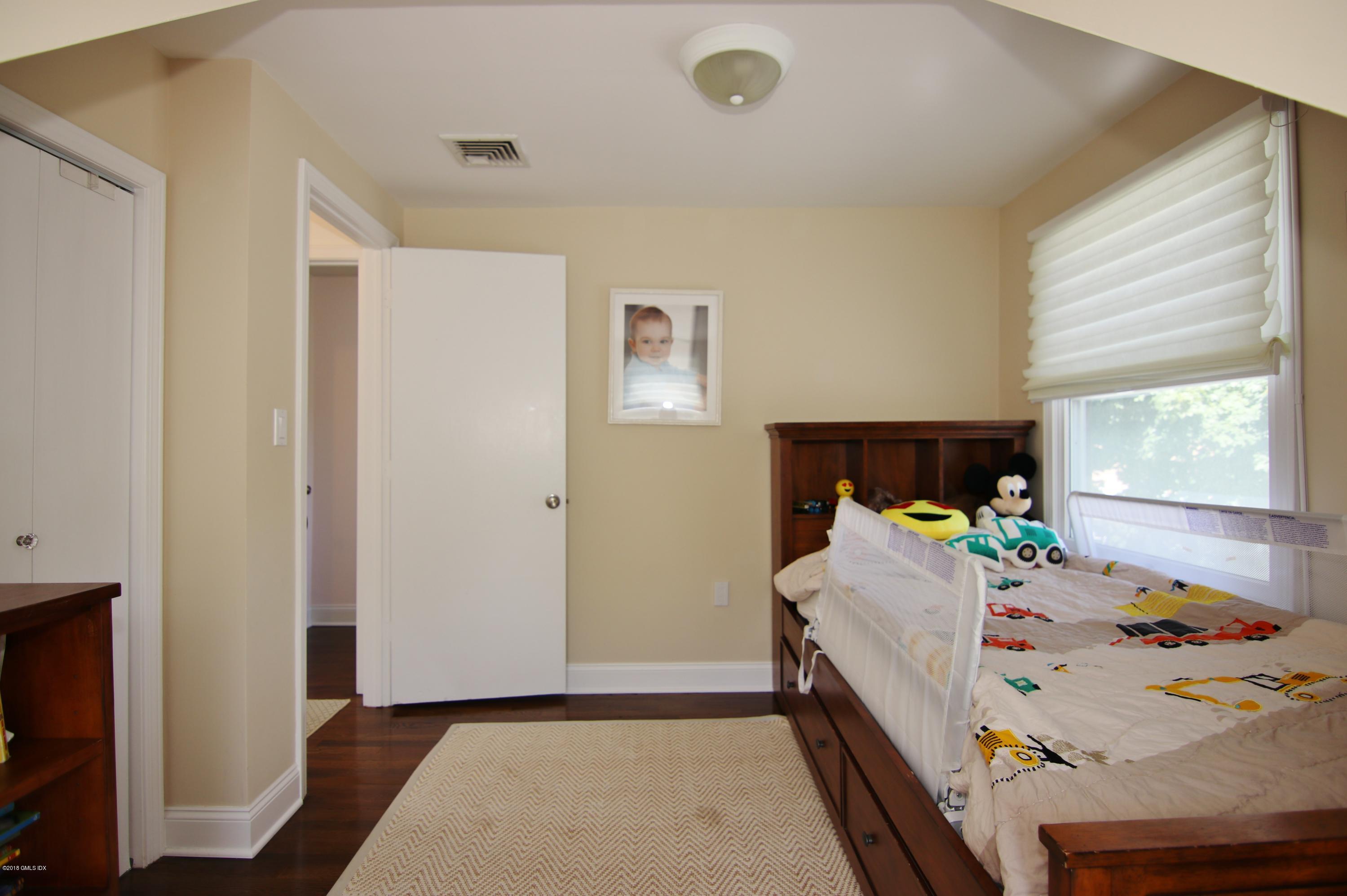 9 Bonwit Road Riverside, CT 06878 - Photo 22 of 29 a bedroom with a bed and a dresser in it