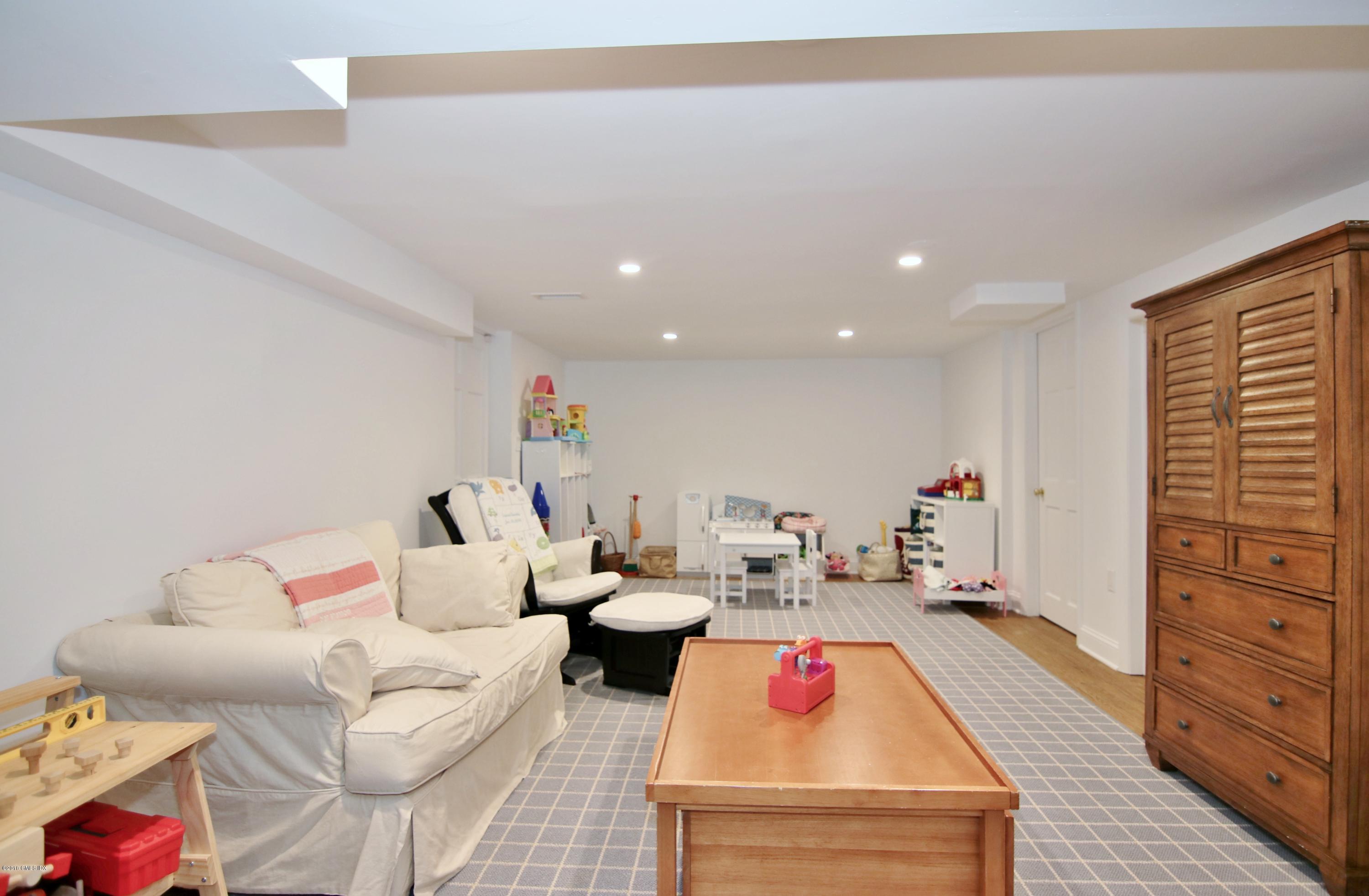9 Bonwit Road Riverside, CT 06878 - Photo 25 of 29 a living room with furniture and a flat screen tv