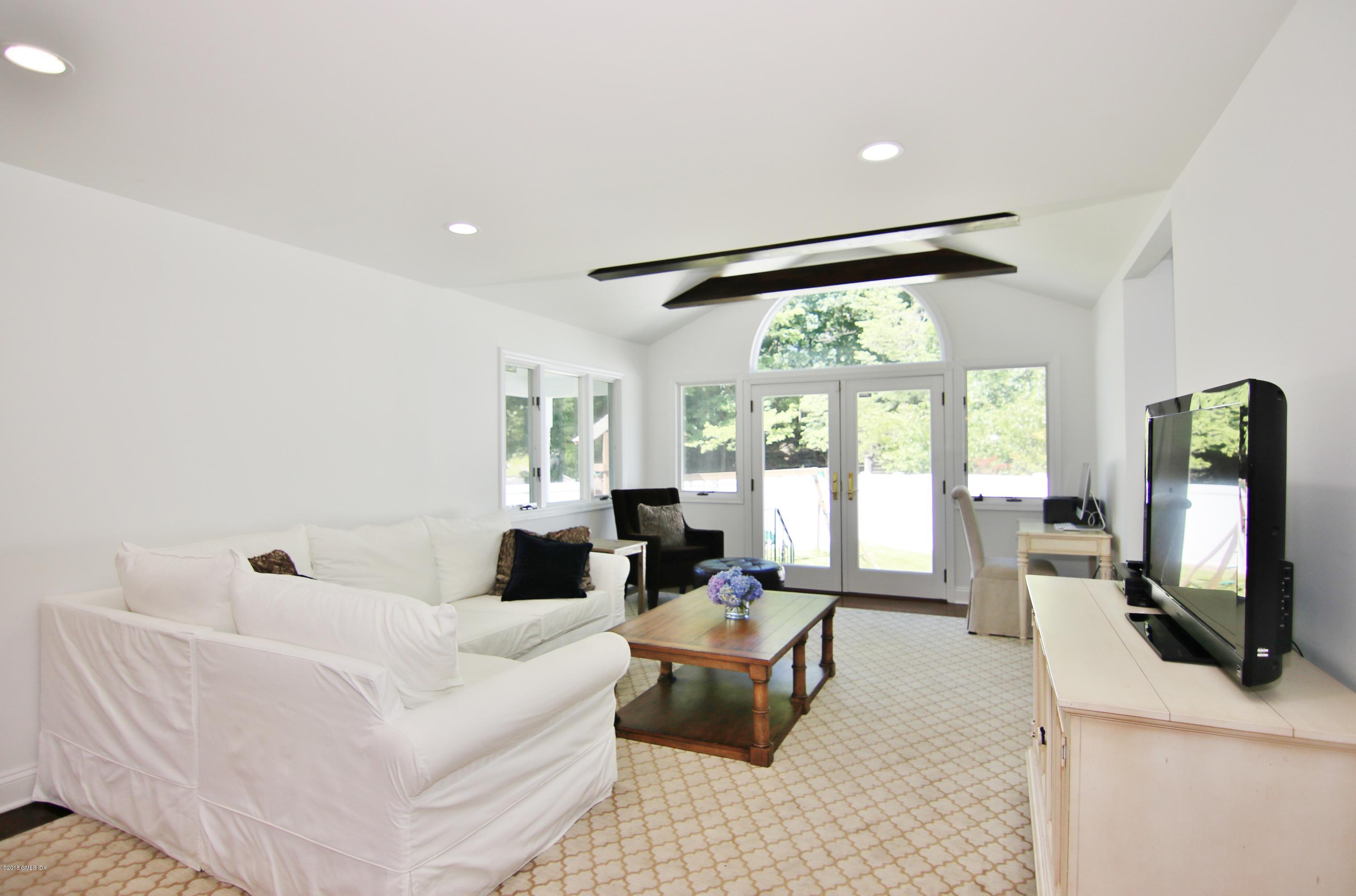 9 Bonwit Road Riverside, CT 06878 - Photo 7 of 29 a living room with furniture flat screen tv and a large window