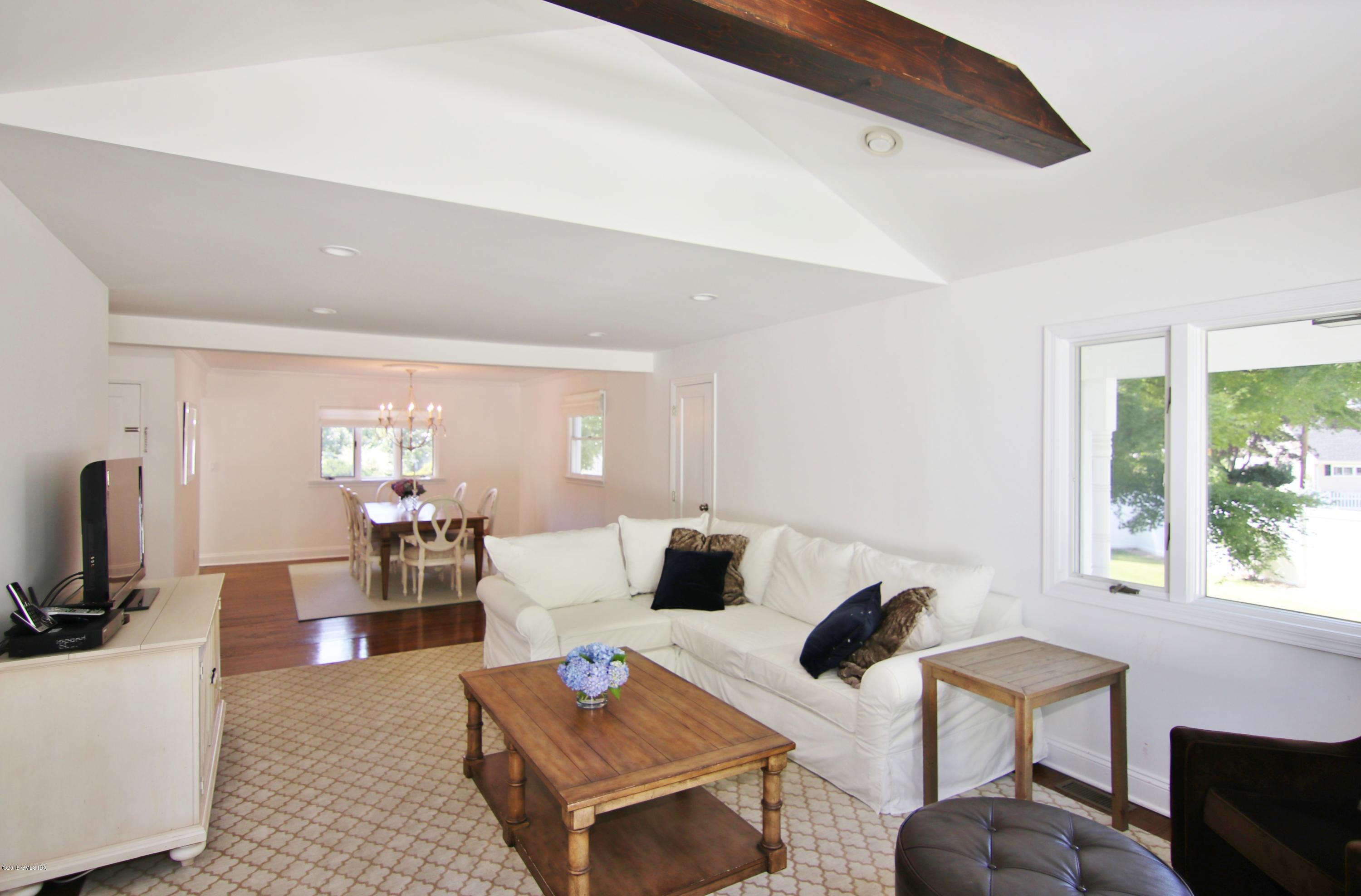 9 Bonwit Road Riverside, CT 06878 - Photo 9 of 29 a living room with furniture a flat screen tv and a large window