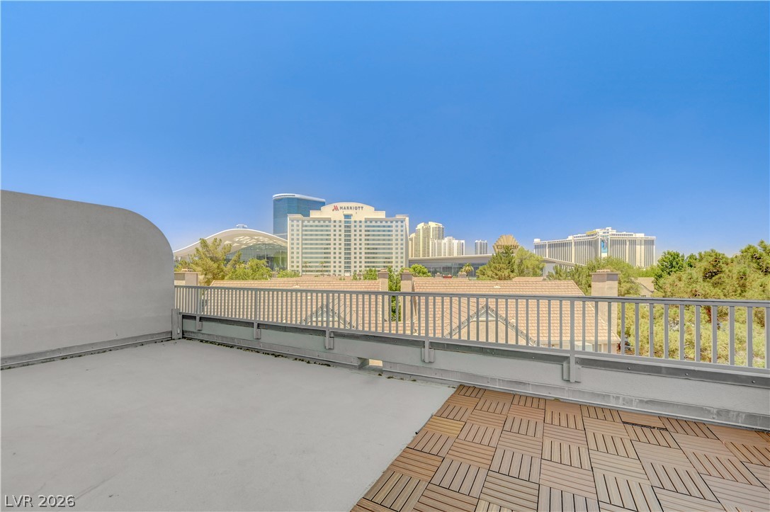 360 East Desert Inn Road, Unit 402 Las Vegas, NV 89109 - Photo 26 of 40 City skyline views complement this modern rooftop deck with durable wood tile flooring.