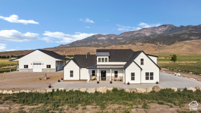 1952 Highway 118 Monroe, UT 84754 - Photo 2 of 88 Rear view of property featuring a standing seam roof, a metal roof, a mountain view, and a patio