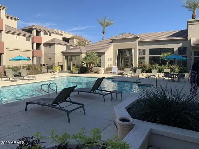 a view of a patio with table and chairs and potted plants