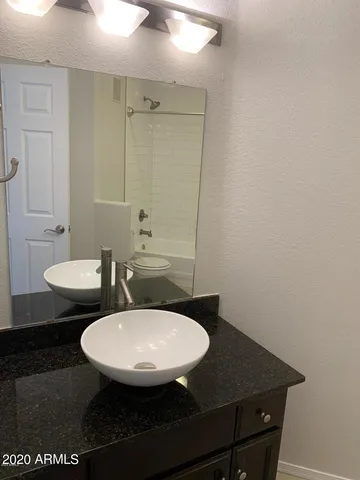a view of a bathroom with a sink and a mirror