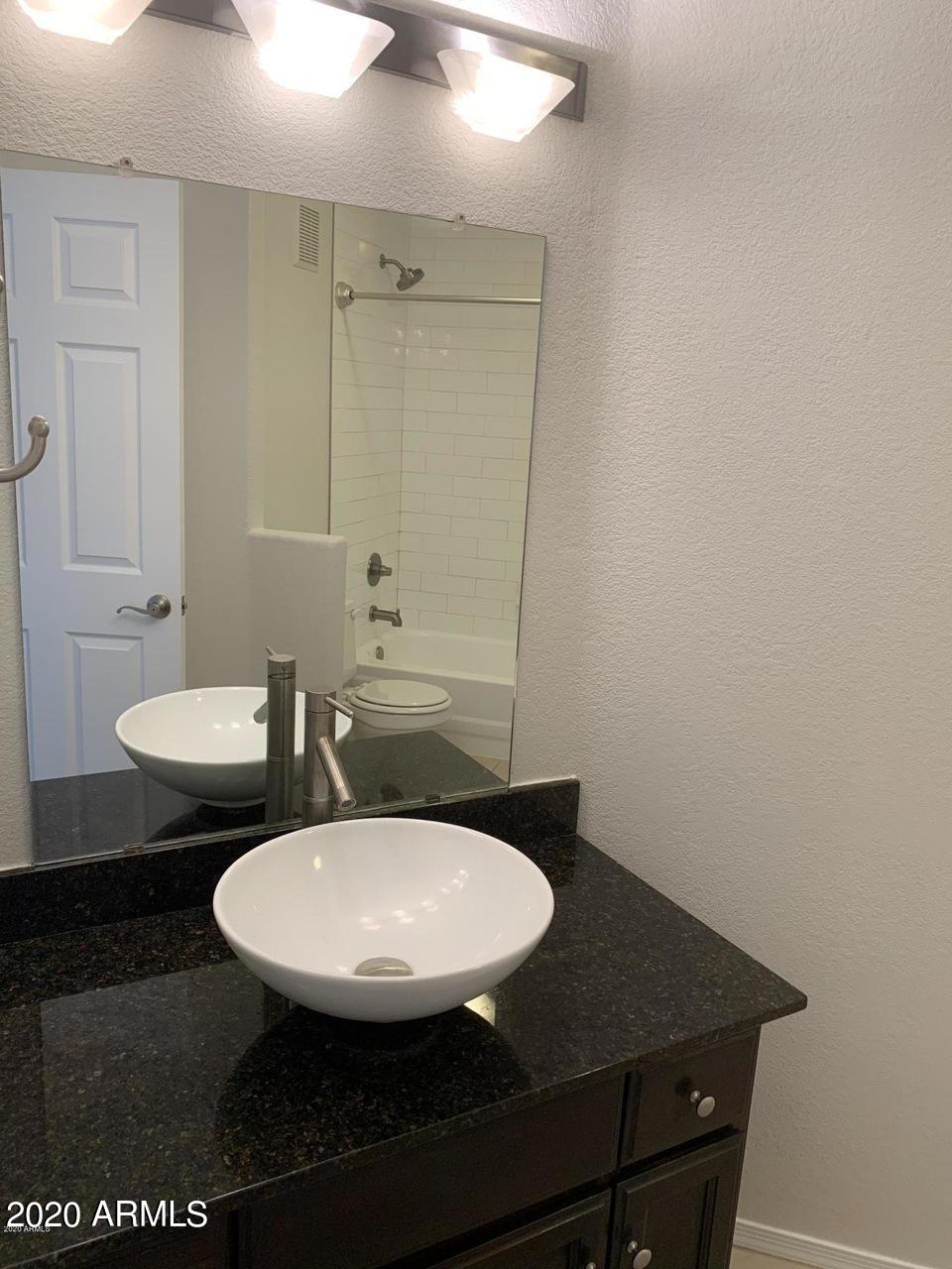 3848 North 3rd Avenue, Unit 3020 Phoenix, AZ 85013 - Photo 11 of 20 a view of a bathroom with a sink and a mirror