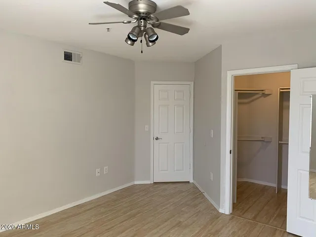 a view of an empty room with a fan