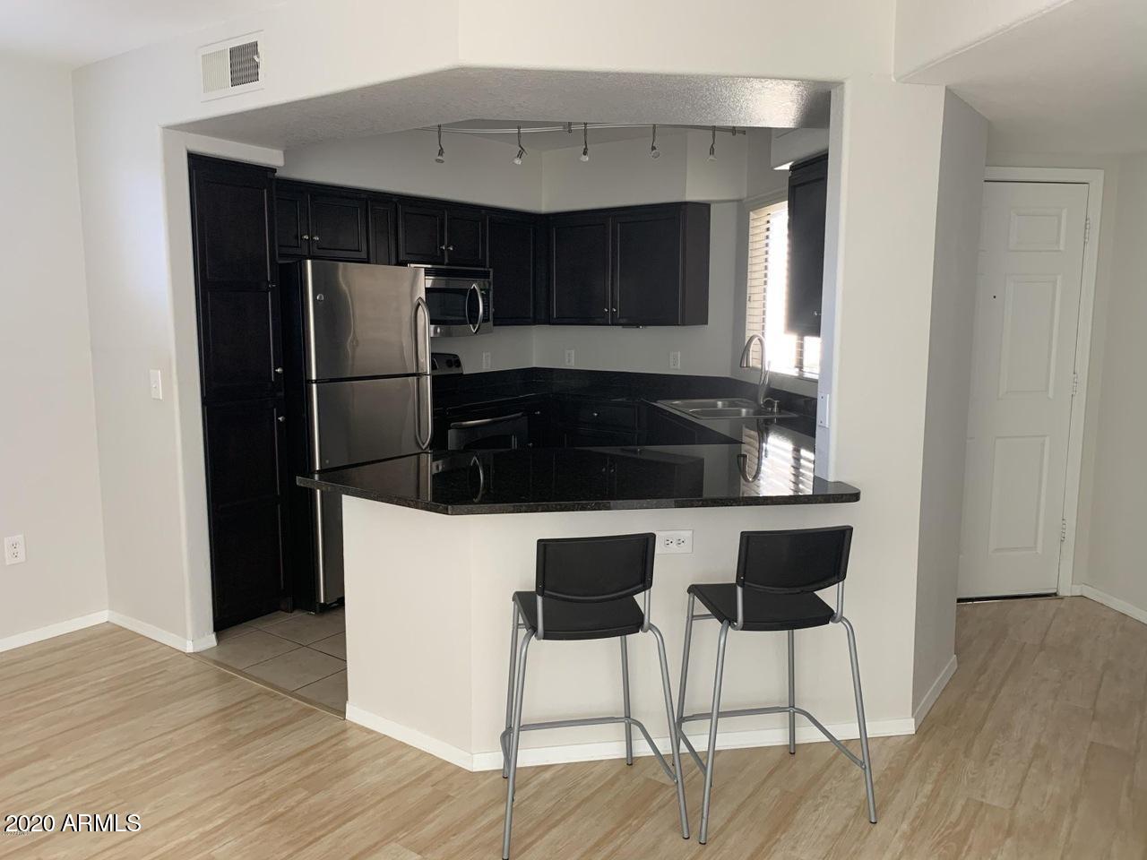 3848 North 3rd Avenue, Unit 3020 Phoenix, AZ 85013 - Photo 2 of 20 a kitchen with a table and chairs in it