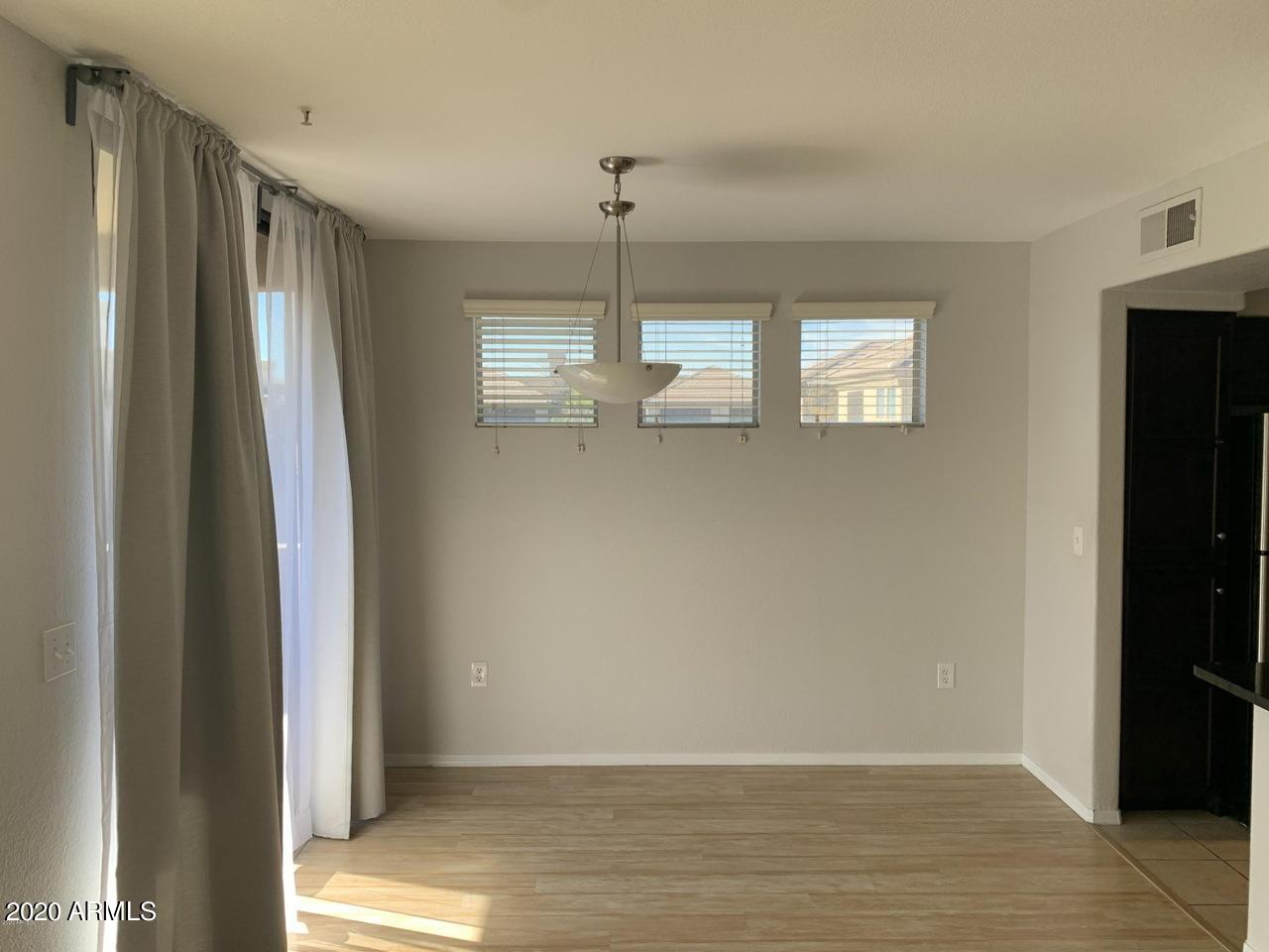 3848 North 3rd Avenue, Unit 3020 Phoenix, AZ 85013 - Photo 6 of 20 a view of empty room with window and ceiling fan