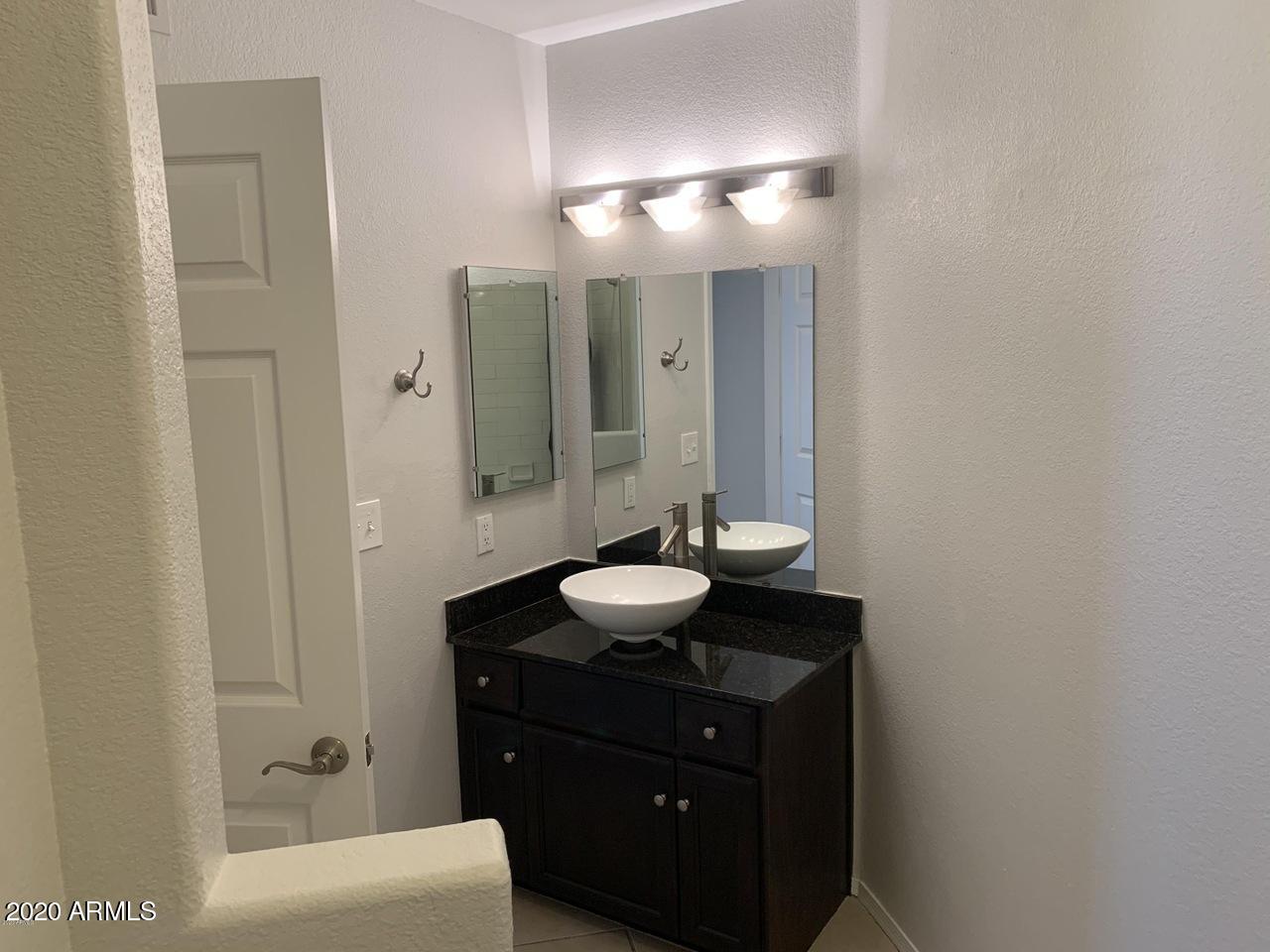 3848 North 3rd Avenue, Unit 3020 Phoenix, AZ 85013 - Photo 10 of 20 a bathroom with a sink and a mirror