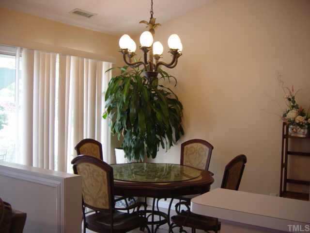 116 Saddle River Road Apex, NC 27502 - Photo 3 of 10 The open breakfast area features new tile flooring and has sliding glass doors leading to the over-sized patio.