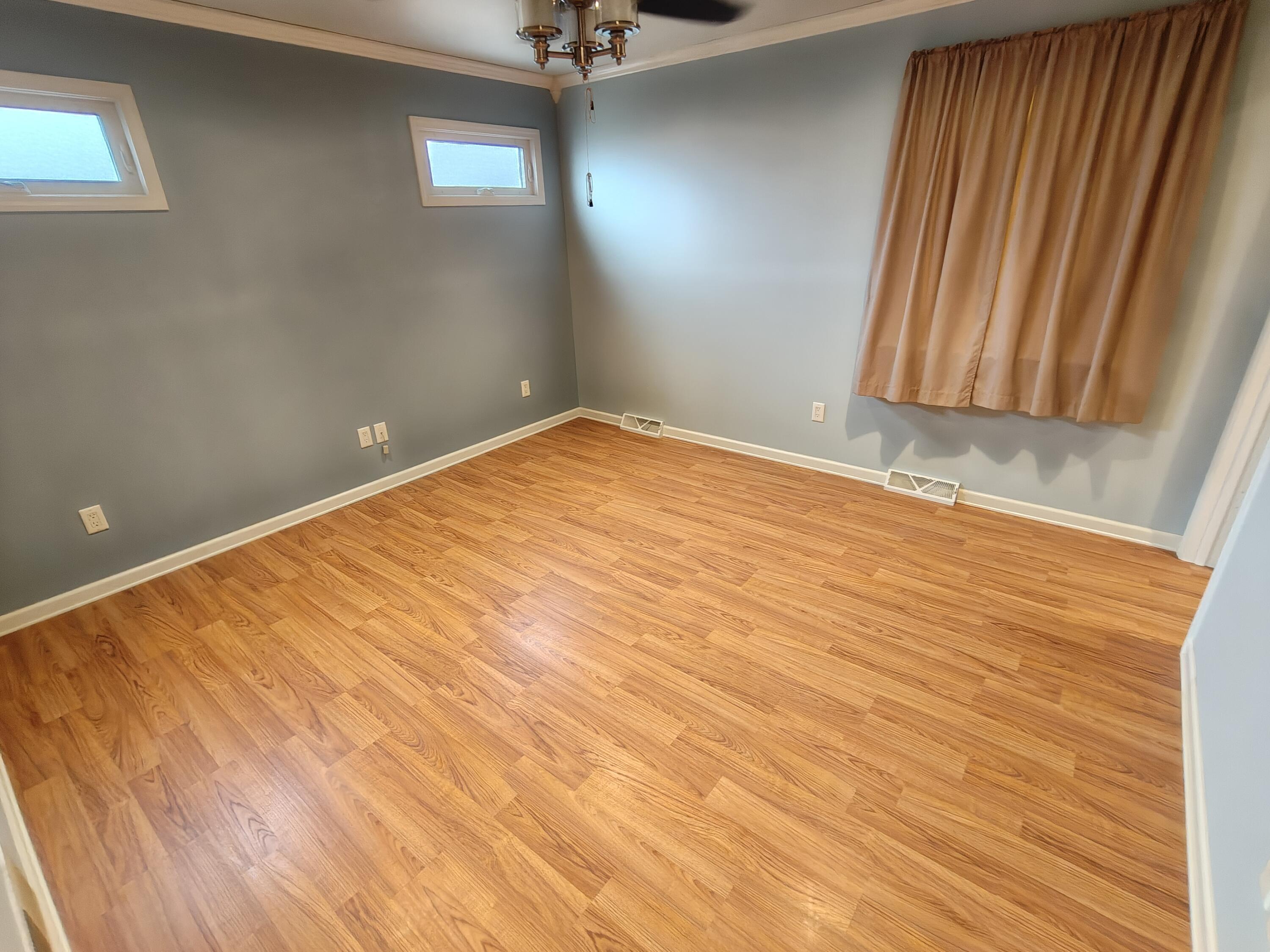 134 Elm Court Hebron, IN 46341 - Photo 13 of 36 an empty room with wooden floor and windows