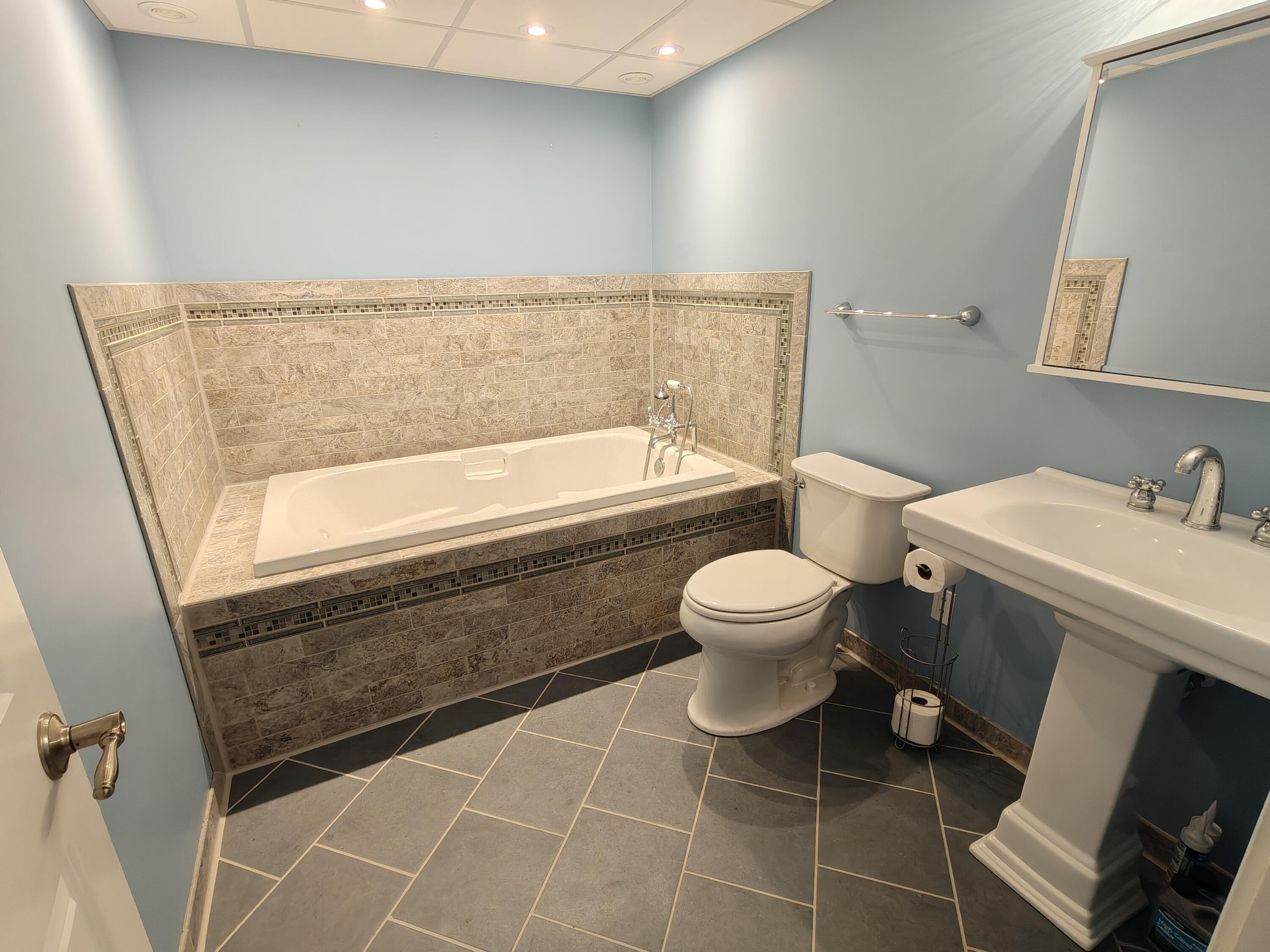 134 Elm Court Hebron, IN 46341 - Photo 20 of 36 a bathroom with a toilet a sink and a bathtub