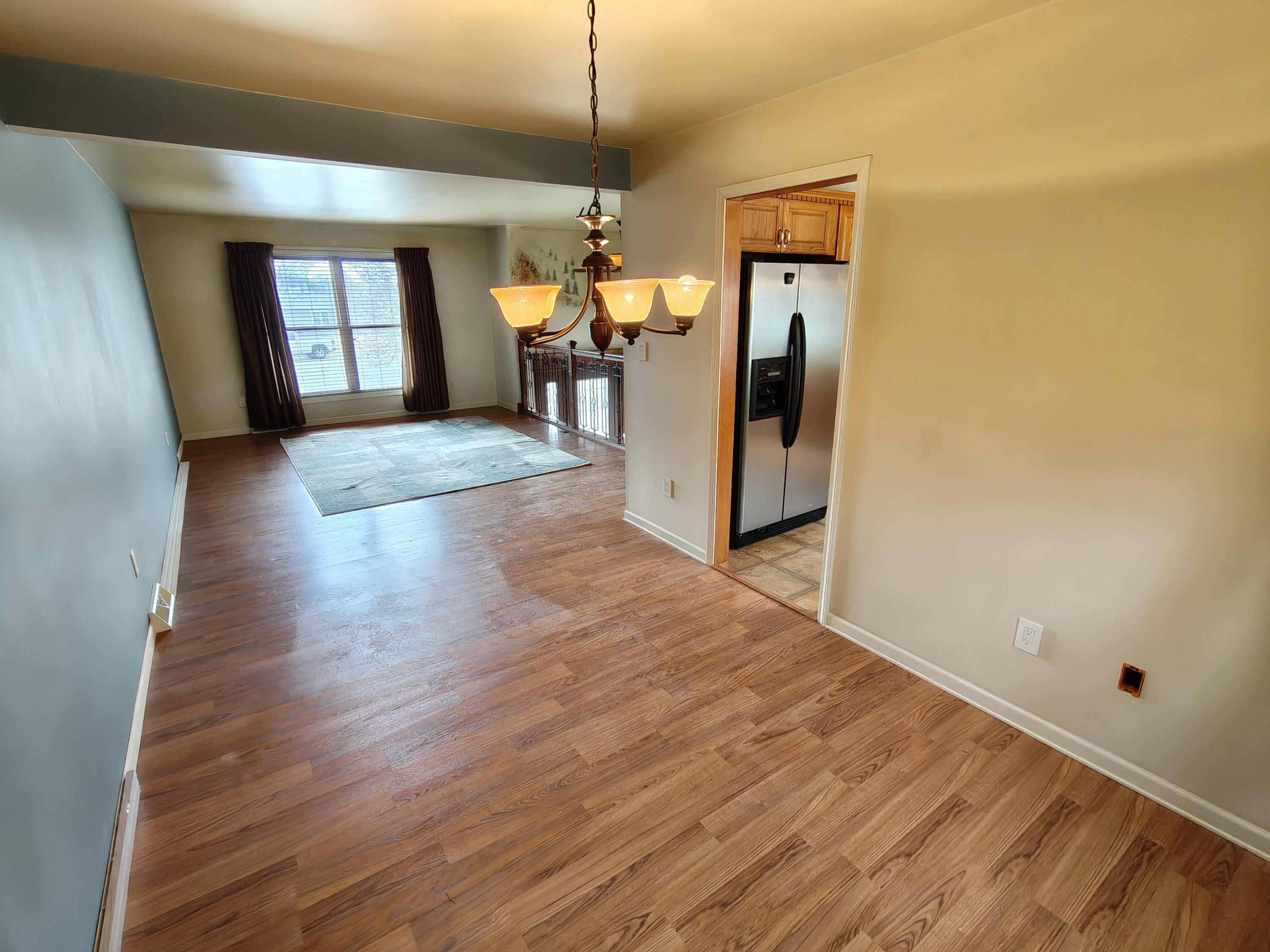 134 Elm Court Hebron, IN 46341 - Photo 5 of 36 a view of a hallway view with wooden floor and chandelier