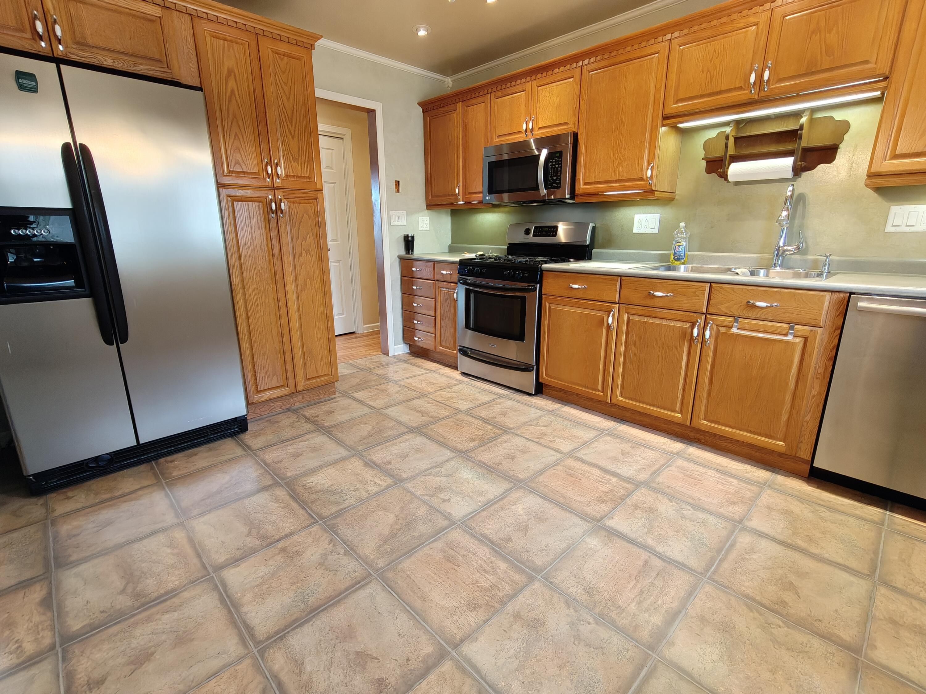 134 Elm Court Hebron, IN 46341 - Photo 7 of 36 a kitchen with stainless steel appliances granite countertop a refrigerator a sink a stove a microwave and island
