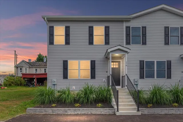 a front view of a house with a yard