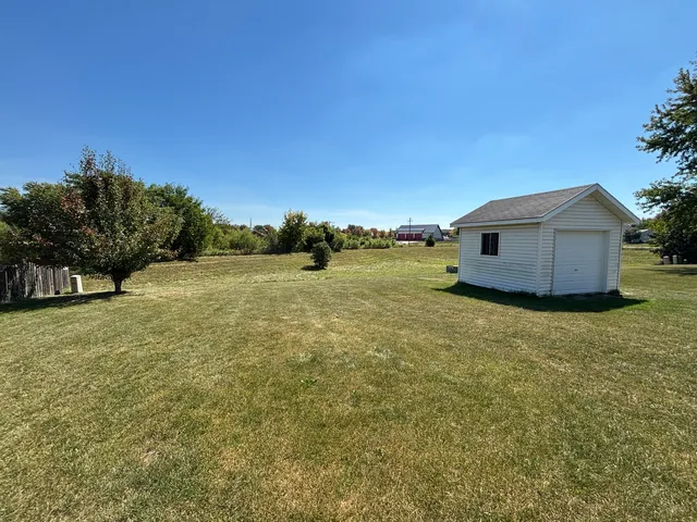 a view of a yard with a house in the background