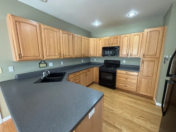 a kitchen with stainless steel appliances a refrigerator sink and cabinets