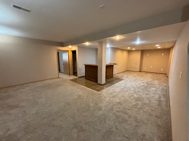 an empty room with a empty space and windows