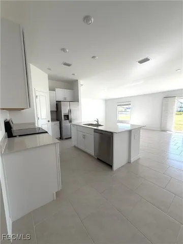 a view of a kitchen with furniture and a window
