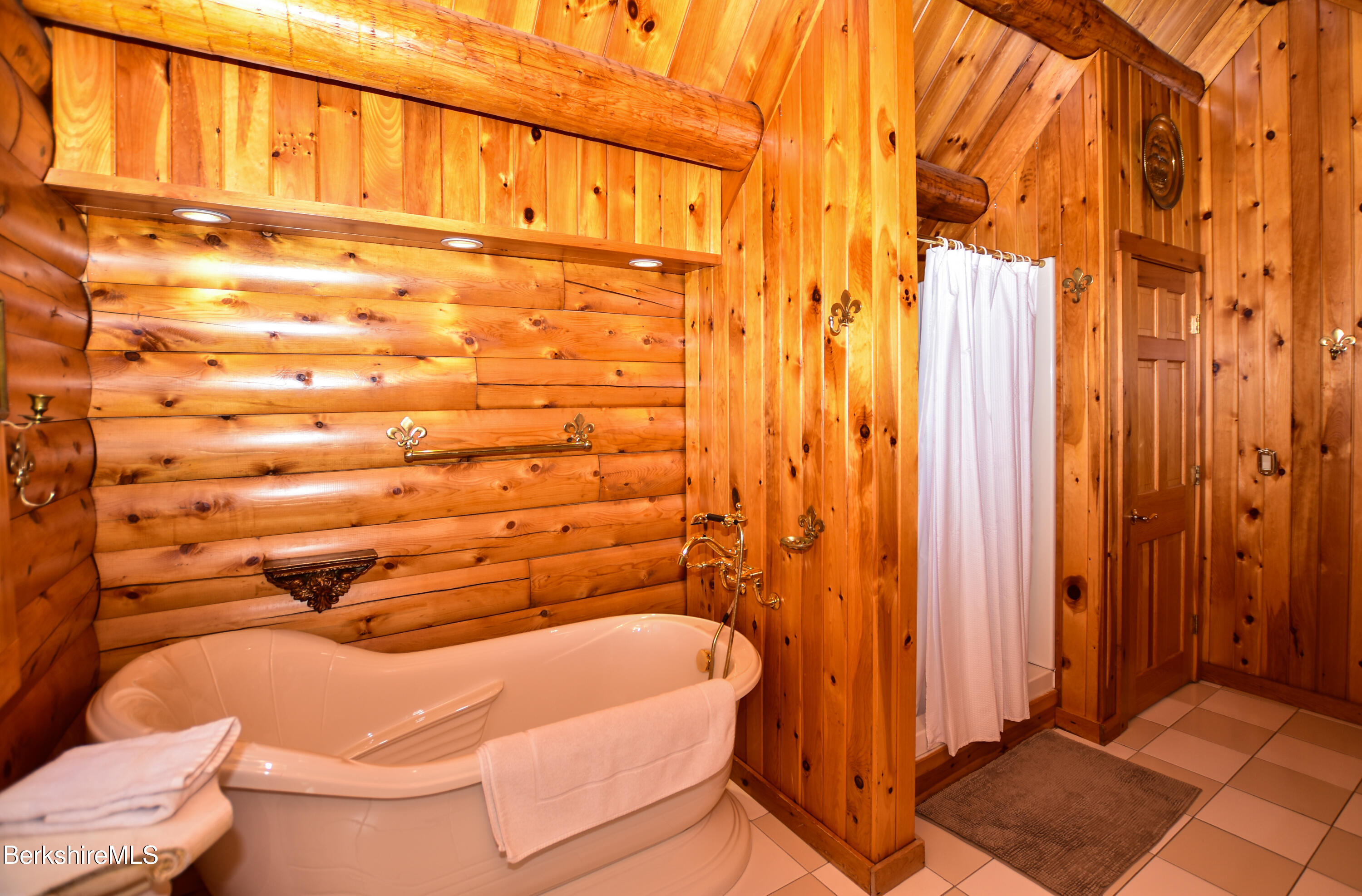 233 Algerie Road Becket, MA 01223 - Photo 33 of 48 a bathroom with a bathtub and shower