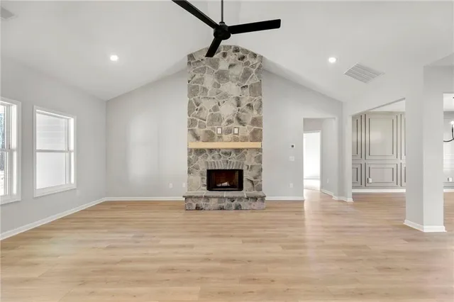 a kitchen with kitchen island granite countertop a sink a counter top space stainless steel appliances and cabinets