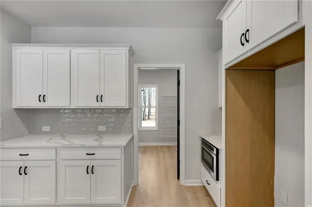 a large kitchen with kitchen island a sink stainless steel appliances and cabinets