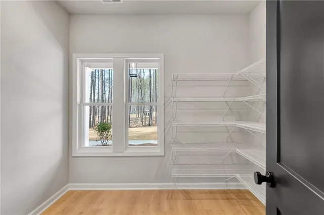 a kitchen with stainless steel appliances a sink a stove a refrigerator a microwave oven and cabinets