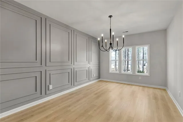 a view of a livingroom with wooden floor a fireplace and window