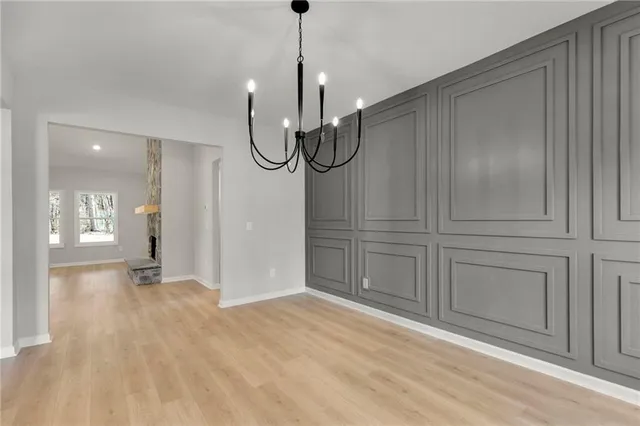 a view of empty room with wooden floor and fireplace