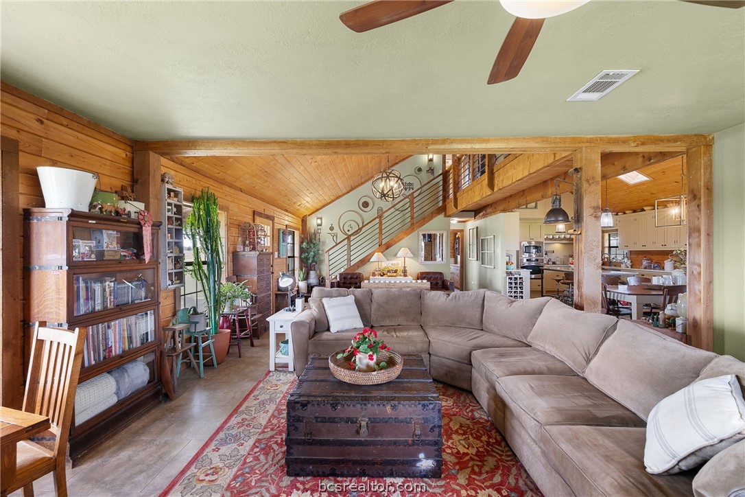 8501 Grassbur Road Bryan, TX 77808 - Photo 13 of 36 a living room with furniture a rug and a floor to ceiling window