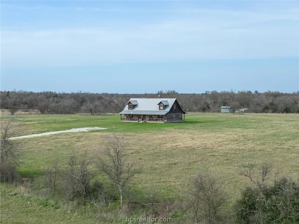a view of a field with an trees