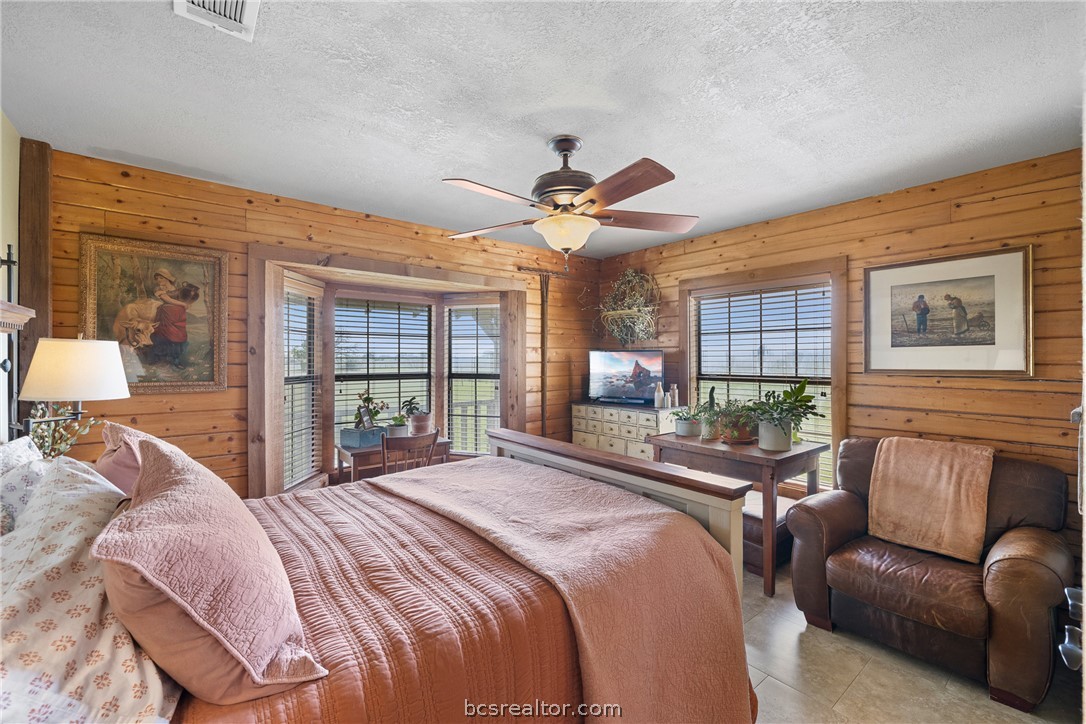 8501 Grassbur Road Bryan, TX 77808 - Photo 22 of 36 a bedroom with a bed a couch and dresser