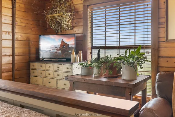 a bedroom with a bed a dresser and a book shelf