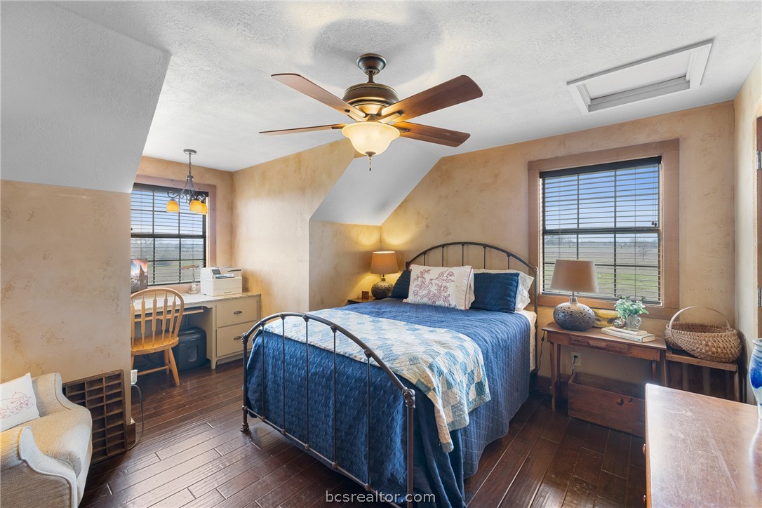 8501 Grassbur Road Bryan, TX 77808 - Photo 30 of 36 a bedroom with a bed and a chandelier