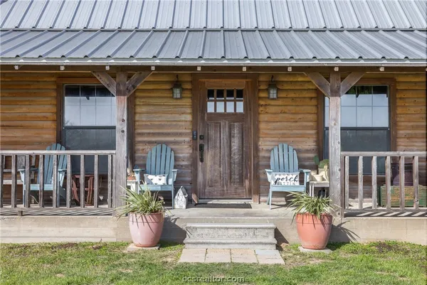 a view of a patio with table and chairs and potted plants
