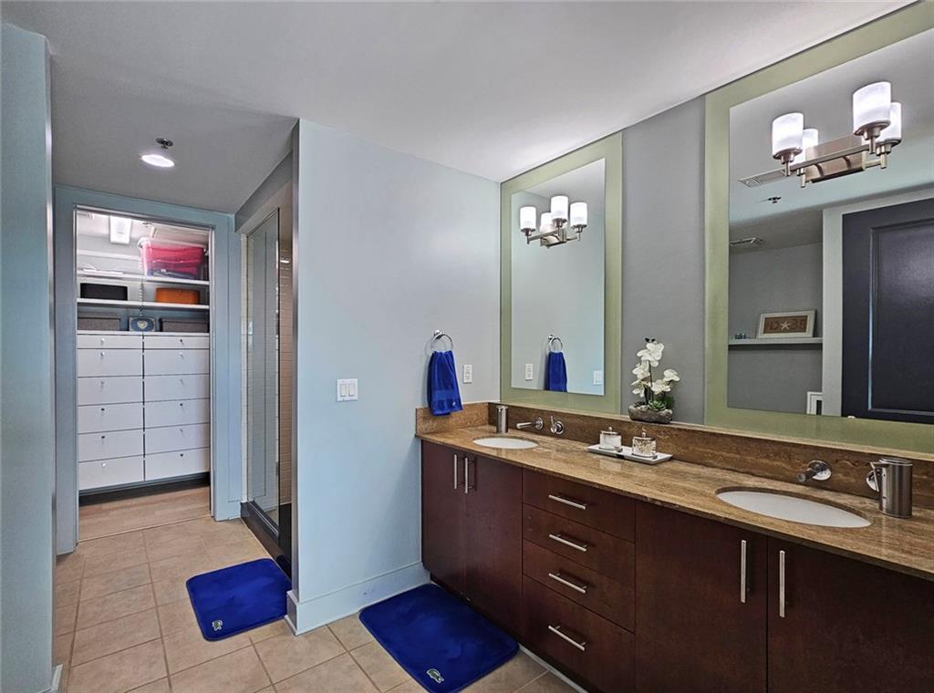 4561 Olde Perimeter Way, Unit 1002 Atlanta, GA 30346 - Photo 11 of 43 a bathroom with a sink and a mirror
