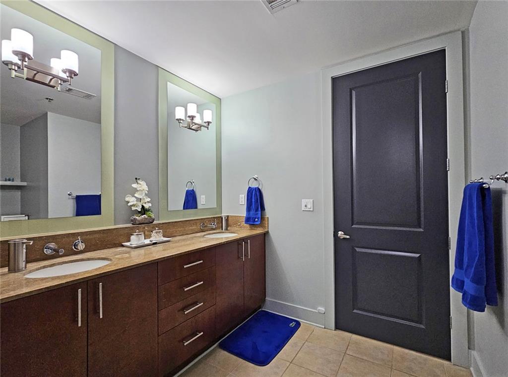 4561 Olde Perimeter Way, Unit 1002 Atlanta, GA 30346 - Photo 12 of 43 a spacious bathroom with a double vanity sink and a mirror